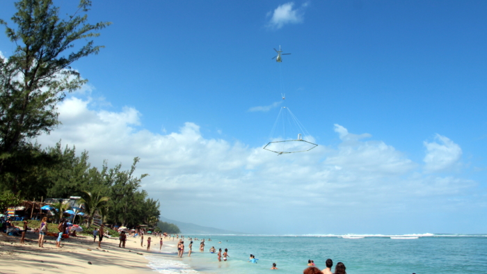 SkyTEM system flying a shoreline near a crowded beac